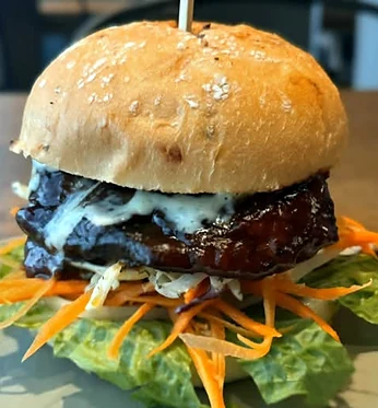 Jerk chicken sandwich with shredded carrots and lettuce