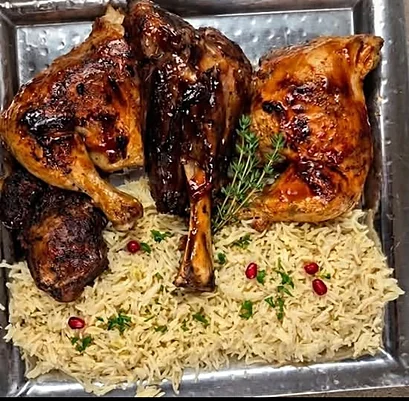 Smoked lamb shank and chicken quarters over rice