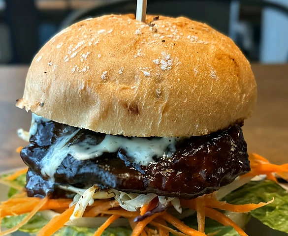 Jerk chicken sandwich with garlic sauce, shredded carrots and lettuce