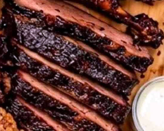 Sliced smoked brisket on a wooden board